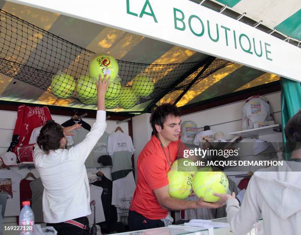 Employees prepare an official Roland Garros products store on May 20, 2010 in Paris at Roland Garros stadium, three days ahead of the French Open,...