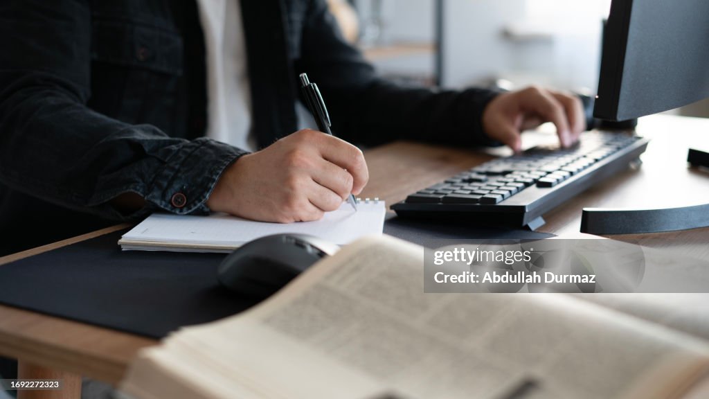 Taking Notes Using Pc University Student Taking Notes While Using Computer High-Res Stock ...