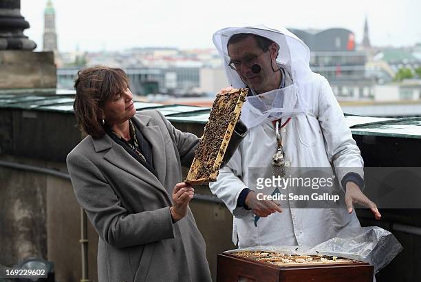 German Agriculture and Consumer Protection Minister Ilse Aigner holds a bees' honeycomb presented to her by beekeper Uwe Marth on the roof of the Dom...