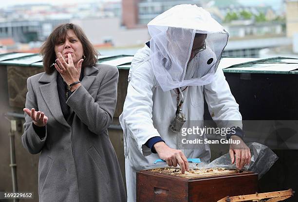 German Agriculture and Consumer Protection Minister Ilse Aigner licks honey from her fingers after holding a bees' honeycomb presented to her by...