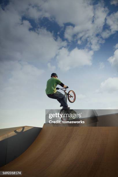 stunt bmx cyclist jumping on ramp - bmx park stock pictures, royalty-free photos & images