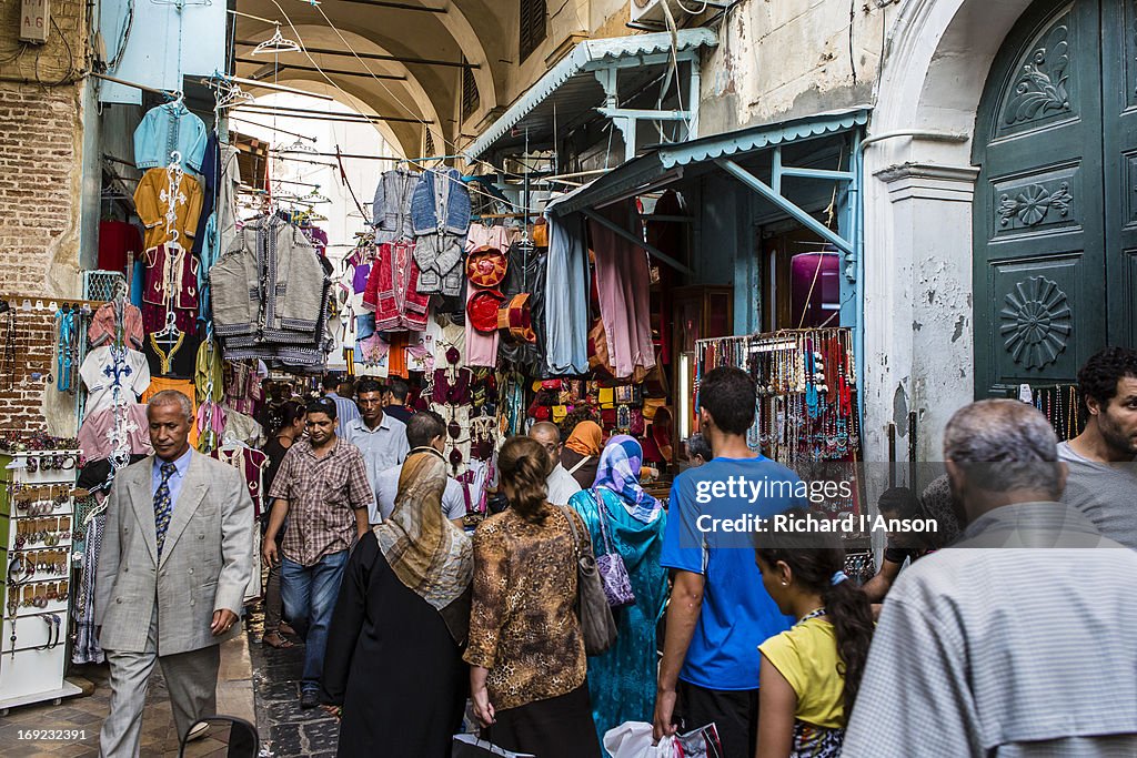 People in vaulted alley in medina