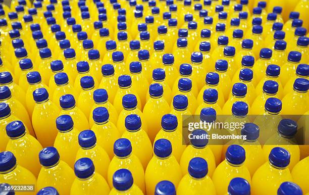 Bottles of Robinsons orange fruit and barley squash drink, produced by Britvic Plc, pass along the production line at the company's factory in...