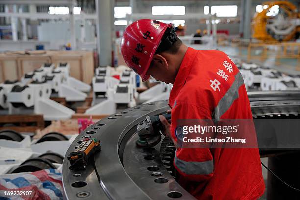 An employee assembles tunnel equipment on May 20, 2013 in Zhengzhou, China. CREC-TMB is one of China's biggest manufactures of Tunnel Boring Machines...