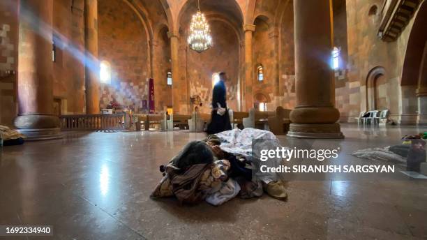 Ethnic Armenians wait in a church to be evacuated from Stepanakert on September 27, 2023. Armenia said on September 27 that 42,500 refugees have...