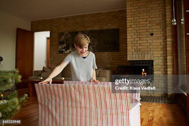 boy opening huge christmas present - open day 12 stock pictures, royalty-free photos & images