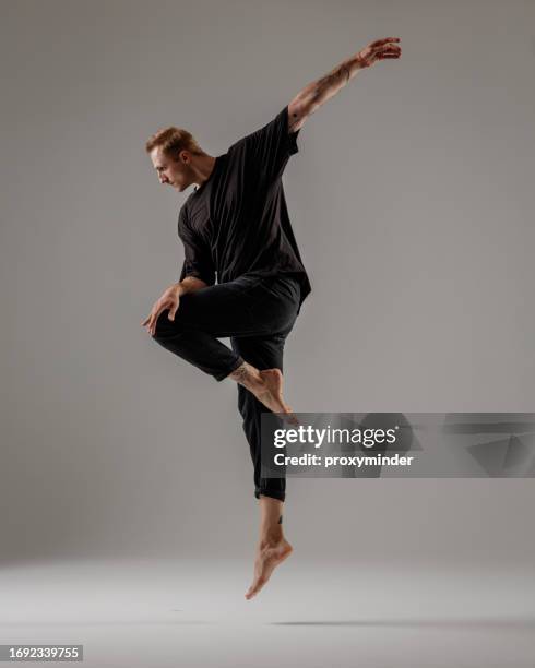 modern male dancer on gray background - modern dancer stock pictures, royalty-free photos & images