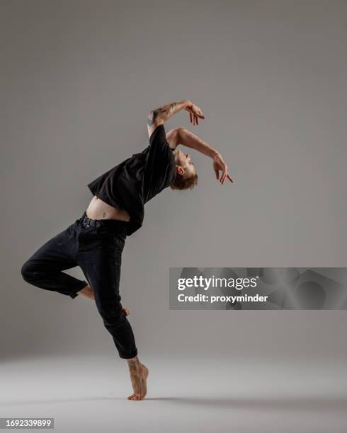 modern male dancer on gray background - modern dancer stock pictures, royalty-free photos & images