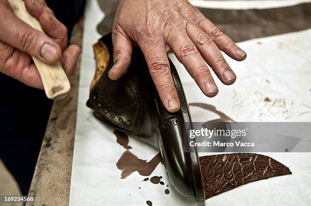 hands polishing handmade shoe - shoe repair stock-fotos und bilder