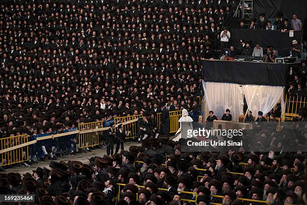 Tens of thousands of Ultra-Orthodox Jews of the Belz Hasidic Dynasty watch the the bride Hannah Batya Penet dances with her relative during the...