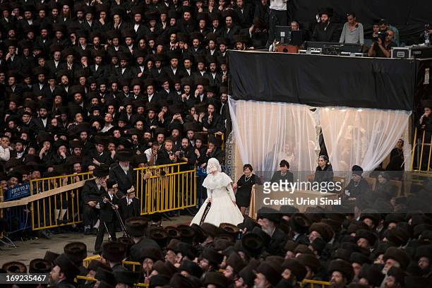 Tens of thousands of Ultra-Orthodox Jews of the Belz Hasidic Dynasty watch the the bride Hannah Batya Penet dances with her relative during the...