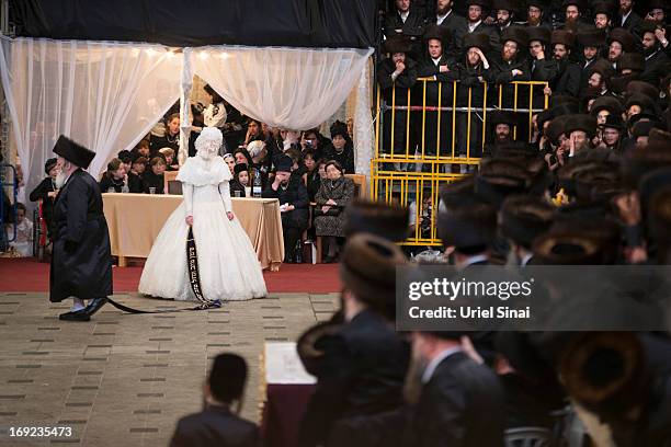 Tens of thousands of Ultra-Orthodox Jews of the Belz Hasidic Dynasty watch the the bride Hannah Batya Penet dances with her relative during the...