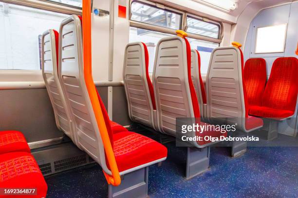 rows of empty seats and a blank ad banner on the underground train carriage - london underground poster stock pictures, royalty-free photos & images