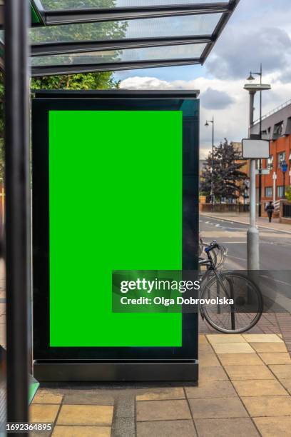a green digital advertising screen on the bus stop - mobile billboard stock pictures, royalty-free photos & images