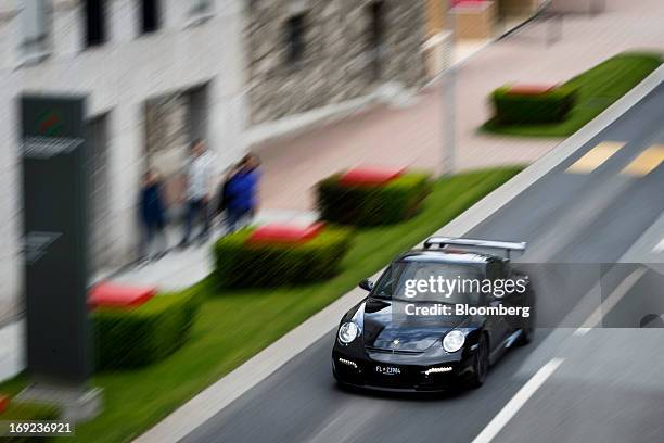 Porsche luxury automobile drives past the headquarters of Liechtensteinische Landesbank AG in Vaduz, Liechtenstein, on Monday, May 20, 2013....