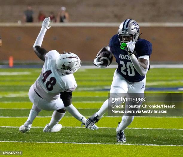 Rice Owls running back Daelen Alexander runs the ball against Texas Southern Tigers linebacker KeShon Spraggins during the second half of a college...