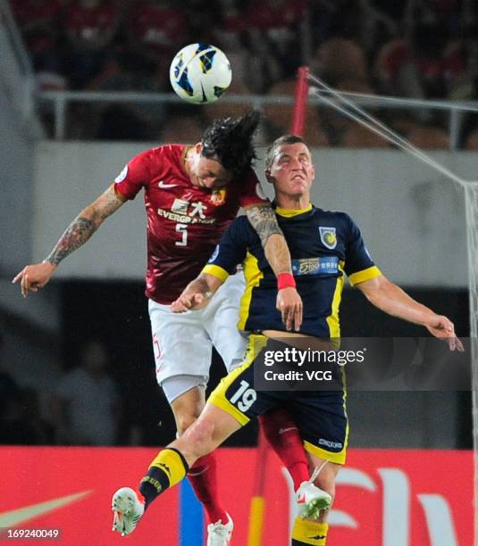 Zhang Linpeng of Guangzhou Evergrande and Mitchell Duke of Central Coast Mariners battle for the ball during the AFC Champions League Round of 16...