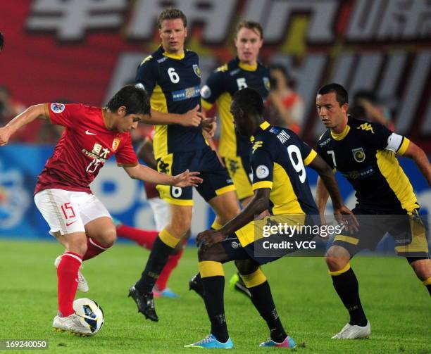 Dario Conca of Guangzhou Evergrande is challenged by Central Coast Mariners players during the AFC Champions League Round of 16 match between...