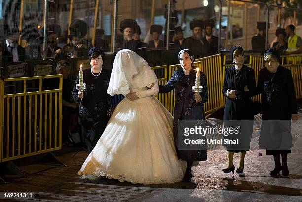 Ultra-Orthodox Jewish women walk with Hannah Batya Penet, the bride of Shalom Rokeach, grandson of the Chief Rabbi of Belz, during a wedding ceremony...