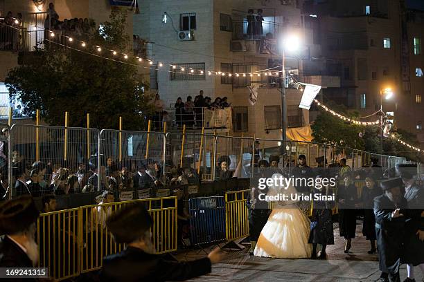 Ultra-Orthodox Jewish women walk with Hannah Batya Penet, the bride of Shalom Rokeach, grandson of the Chief Rabbi of Belz, during a wedding ceremony...