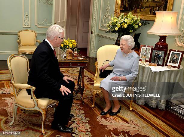 Queen Elizabeth II speaks with the President of Croatia Ivo Josipovic during a private audience at Buckingham Palace in London on May 22, 2013. AFP...