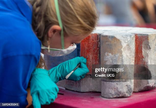 French conservation artist works to clean fire-damaged painted stone for the renovation of Notre Dame Cathedral in Paris, France. The ancient...