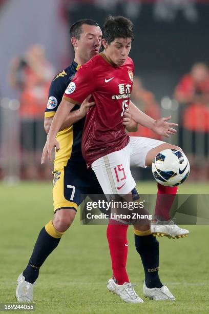 Dario Leonardo Conca of Guangzhou Evergrande challenges John Hutchinson of Central Coast Mariners during the AFC Champions League knockout round...