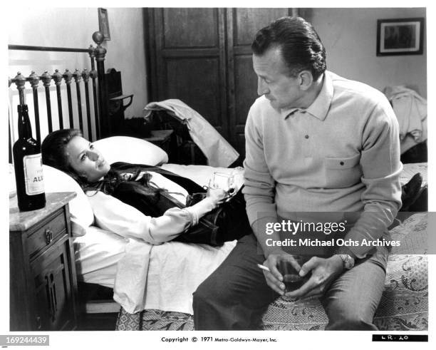 Trish Van Devere lies in bed with George C Scott in a scene from the film 'The Last Run', 1971.