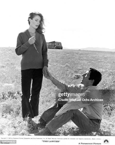 Diana Muldaur and Barry Newman hold hands in a scene from the film 'The Lawyer', 1970.