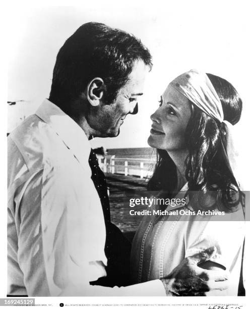 Tony Curtis holds Anjanette Comer in a scene from the film 'Lepke', 1975.