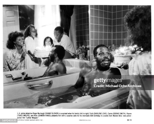 Darlene Love, Ebonie Smith, Traci Wolfe and Damon Hines surprise Danny Glover in a scene from the film 'Lethal Weapon', 1987.