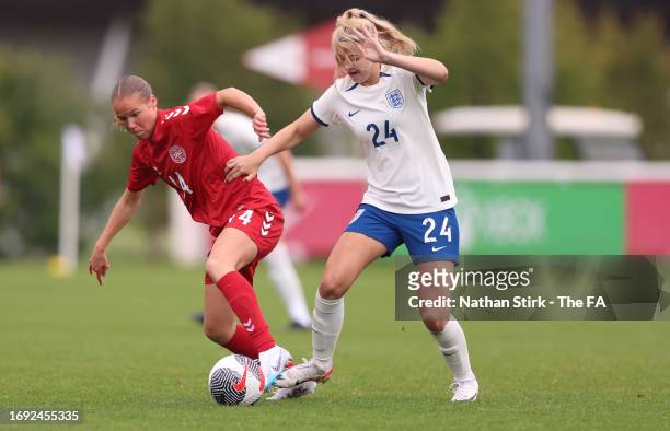 Lexi Potter of England runs past Karoline Oleson of Denmark during the Women's International match between England U19 and Denmark U19 at St Georges...