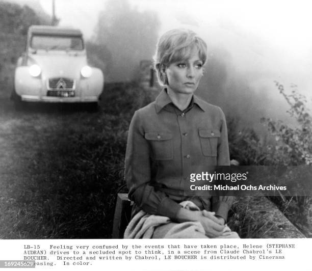 Stephane Audran sits on a ridge in a scene from the film 'Le Boucher', 1970.