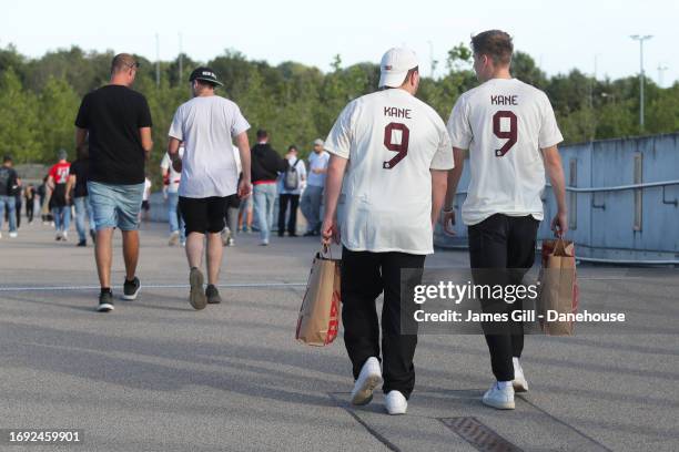 Two Bayern Munich supporters are seen wearing shirts depicting the name of Harry Kane of Bayern Munich prior to the UEFA Champions League match...