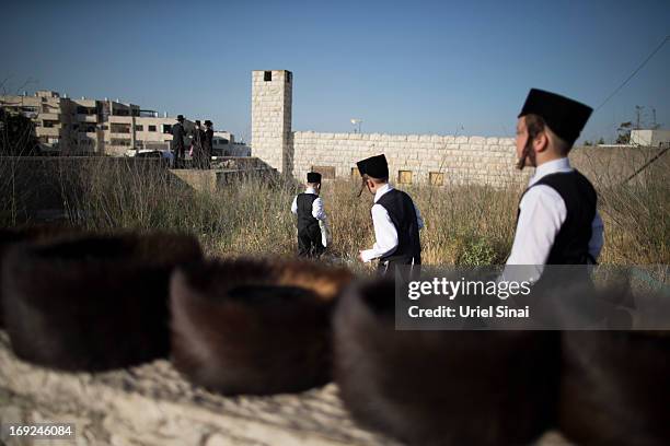 Children play as tens of thousands of Ultra-Orthodox Jews attend the wedding of Rabbi Shalom Rokeach, the grandson of the leader of the Belz Rebbe...