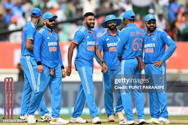 India's Mohammed Siraj celebrates with teammates after taking the wicket of Australia's Steve Smith during the third and final one-day international...