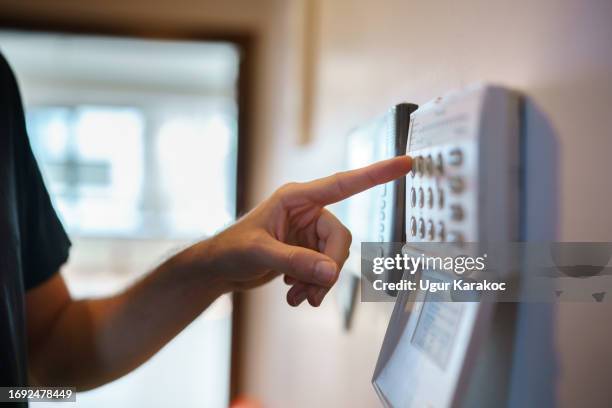 setting up the home security alarm - alarm stock pictures, royalty-free photos & images