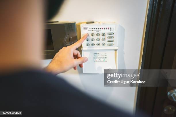 setting up the home security alarm - alarm system stock pictures, royalty-free photos & images
