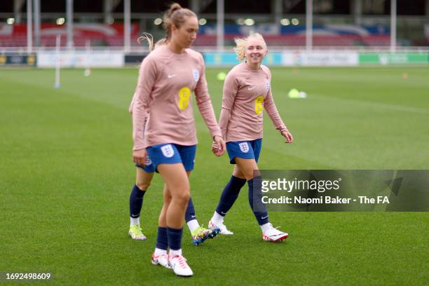 Lucy Parker and Katie Robinson of England walk out prior to a training session at St George's Park on September 20, 2023 in Burton upon Trent,...