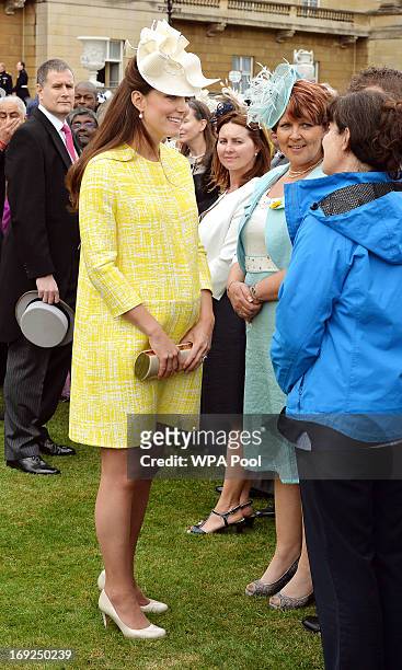 Catherine, Duchess of Cambridge talks to guests as she attends a Garden Party in the grounds of Buckingham Palace hosted by Queen Elizabeth II on May...