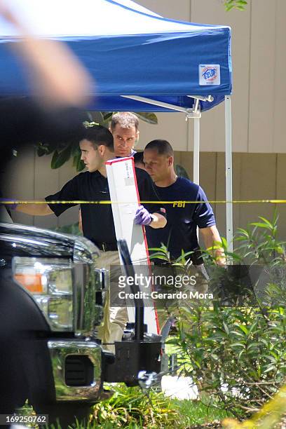 Federal Bureau of Investigation evidence response team takes out evidence from an apartment where a suspected friend of the Boston bombers was shot...