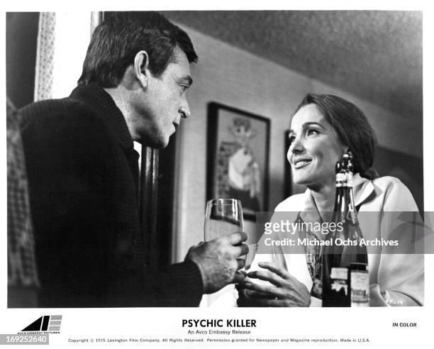 Paul Burke and Julie Adams drink wine in a scene from the film 'Psychic Killer', 1975. (Photo by AVCO/Getty Images