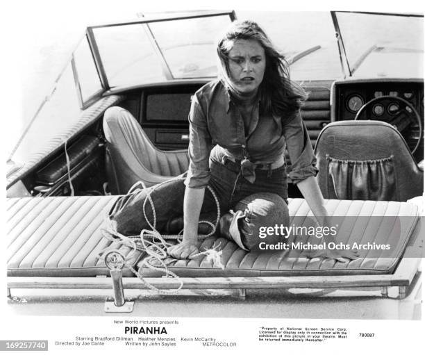 Heather Menzies-Urich sits on the back of a boat in a scene from the film 'Piranha', 1978.