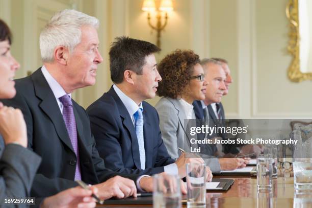 business people sitting in meeting - botschafter stock-fotos und bilder