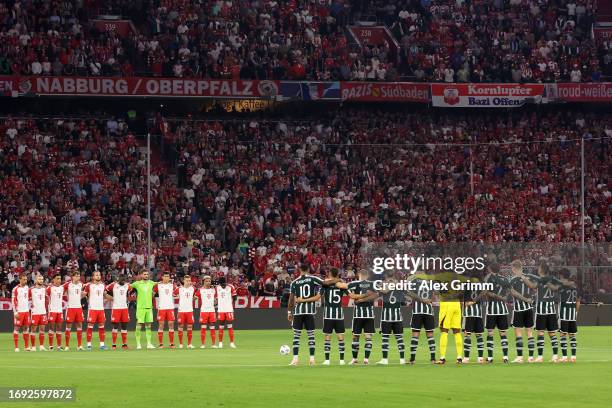 Players, fans and officials hold a minutes silence in memory of the victims of the earthquakes in Morocco and Libya prior to the UEFA Champions...
