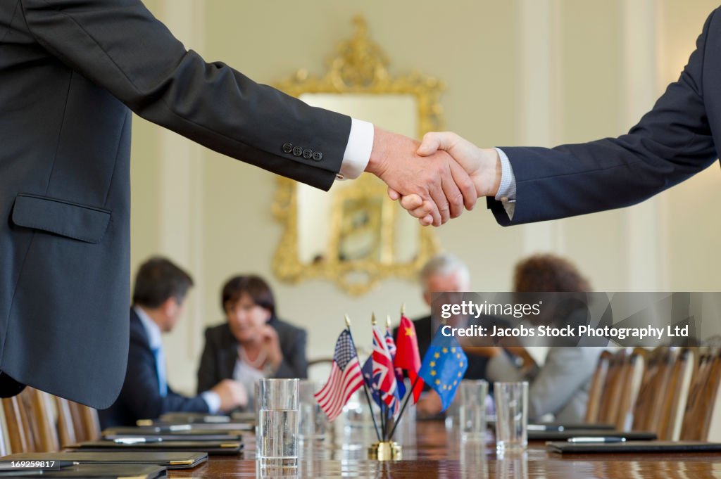 Businessmen shaking hands in meeting