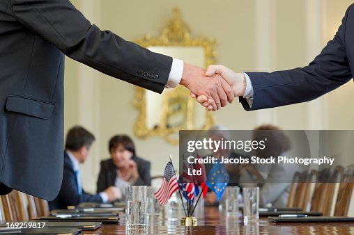 Businessmen shaking hands in meeting Businessmen shaking hands in meeting