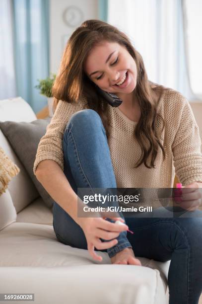 hispanic girl painting her toenails - teen girls toes stock pictures, royalty-free photos & images