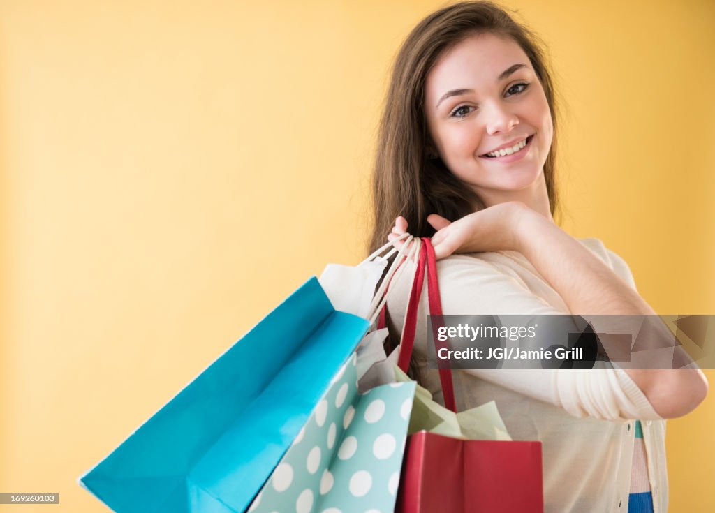 Hispanic girl carrying shopping bags