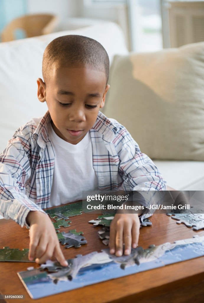 African American boy playing with jigsaw puzzle